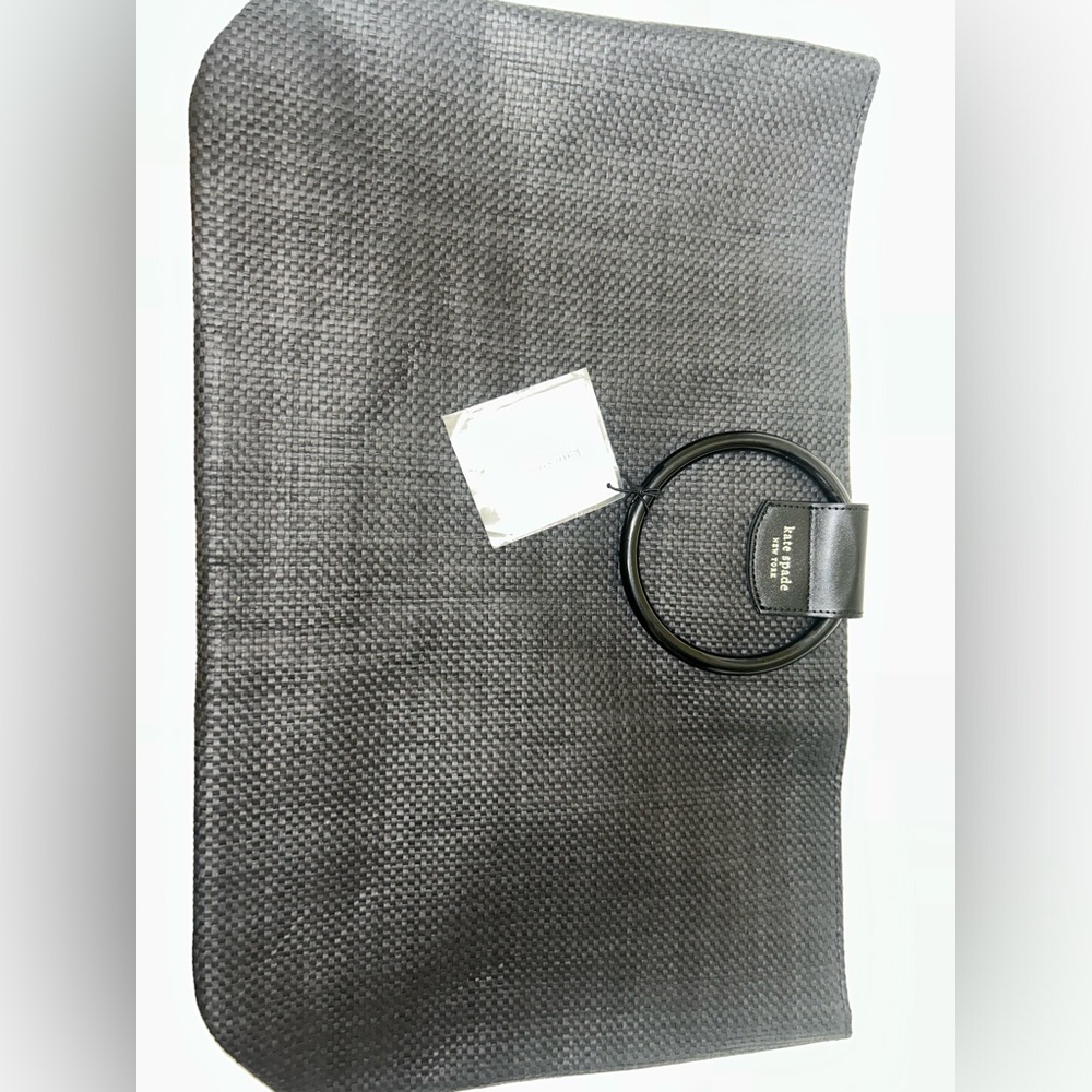 Black woven Kate spade bag with silver magnetic clasp. Round black handles